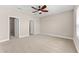 Unfurnished bedroom includes carpet, a ceiling fan, and two closets at 13487 Old Creek Ct, Parrish, FL 34219