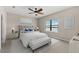 Comfortable bedroom featuring a padded headboard, bench, and a serene water view at 13487 Old Creek Ct, Parrish, FL 34219