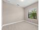 Clean bedroom with neutral carpet, a window overlooking a green view, and neutral-painted walls at 13487 Old Creek Ct, Parrish, FL 34219