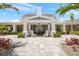 Elegant clubhouse entrance featuring rocking chairs, columns, and a welcoming patio area at 13487 Old Creek Ct, Parrish, FL 34219