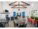 Spacious clubhouse interior with high ceilings, exposed beams, modern furnishings, and a kitchen at 13487 Old Creek Ct, Parrish, FL 34219