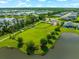 Aerial view of the community dog park nestled between a lake and residential homes at 13487 Old Creek Ct, Parrish, FL 34219