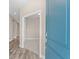 Bright entryway featuring wood-look tile flooring and a glimpse into a carpeted room through an open door at 13487 Old Creek Ct, Parrish, FL 34219