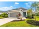 Charming single-story home featuring manicured landscaping, a two-car garage, and a welcoming entrance at 13487 Old Creek Ct, Parrish, FL 34219