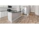 Stylish kitchen island featuring a sleek black countertop and modern cabinetry at 13487 Old Creek Ct, Parrish, FL 34219