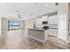 Bright, modern kitchen with white cabinets, black countertops, and an island overlooking the lake at 13487 Old Creek Ct, Parrish, FL 34219