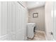 Laundry room features white washer/dryer, shelving, and a window at 13487 Old Creek Ct, Parrish, FL 34219