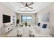 Bright living room features stylish furnishings and large windows overlooking a tranquil lake at 13487 Old Creek Ct, Parrish, FL 34219