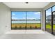 Screened lanai provides stunning water view with lush green grass at 13487 Old Creek Ct, Parrish, FL 34219