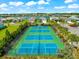 Aerial view of community pickleball courts with lush landscaping under a sunny sky at 13487 Old Creek Ct, Parrish, FL 34219