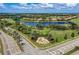 Community aerial view featuring a pond, golf course, upscale homes, and well-maintained landscaping at 135 River Enclave Ct, Bradenton, FL 34212