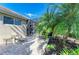 Relaxing backyard with a lounge chair, view to screened in patio, and lovely landscaping at 135 River Enclave Ct, Bradenton, FL 34212