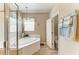 Elegant bathroom with a soaking tub, chandelier, and neutral color palette at 135 River Enclave Ct, Bradenton, FL 34212