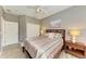 Bedroom with gray walls, closet, ceiling fan, wood-look floors, and a nightstand at 135 River Enclave Ct, Bradenton, FL 34212