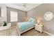 Well-lit bedroom featuring wood-look flooring, a ceiling fan, and neutral wall color at 135 River Enclave Ct, Bradenton, FL 34212