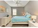 Bright bedroom featuring a white bed, matching furniture, wood-look floors, and neutral decor at 135 River Enclave Ct, Bradenton, FL 34212