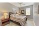 Cozy bedroom features wood-look flooring, a modern ceiling fan, and a coordinated color scheme at 135 River Enclave Ct, Bradenton, FL 34212