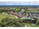 Stunning aerial view of the clubhouse, swimming pool and golf course in a beautiful, well-maintained community at 135 River Enclave Ct, Bradenton, FL 34212