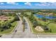 Scenic aerial view of the community entrance with lush landscaping and a decorative water feature at 135 River Enclave Ct, Bradenton, FL 34212