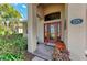 Charming home exterior showcasing a decorative glass front door and well-manicured landscaping at 135 River Enclave Ct, Bradenton, FL 34212