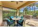 Screened-in lanai featuring a hot tub, seating area, and views of tropical landscape at 135 River Enclave Ct, Bradenton, FL 34212