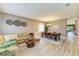 Comfortable living room with neutral tones and dining area that offers natural light and wood-style flooring at 135 River Enclave Ct, Bradenton, FL 34212