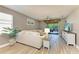 Comfortable living area boasts a large sofa, wood-look flooring, and sliding glass doors to the outdoor living area at 135 River Enclave Ct, Bradenton, FL 34212
