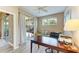 Well-lit office with a sliding door to the lanai, a work desk, and neutral decor at 135 River Enclave Ct, Bradenton, FL 34212