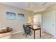 Cozy office space featuring neutral tones, wood-look flooring, and views into the bedroom at 135 River Enclave Ct, Bradenton, FL 34212