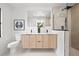 Modern bathroom with double vanity, sleek fixtures, and glass-enclosed shower at 1406 N Riverhills Dr, Temple Terrace, FL 33617