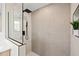 Shower features sleek fixtures and modern tile at 1406 N Riverhills Dr, Temple Terrace, FL 33617