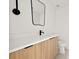 Modern bathroom with wood grain vanity, white countertops, and black faucet/hardware at 1406 N Riverhills Dr, Temple Terrace, FL 33617
