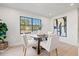 Bright breakfast nook features a round table, stylish chairs, and natural light from large windows at 1406 N Riverhills Dr, Temple Terrace, FL 33617