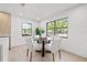Bright breakfast nook features a round table, stylish chairs, and large windows with views of the greenery at 1406 N Riverhills Dr, Temple Terrace, FL 33617