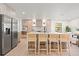 Modern kitchen features a large island with seating, stainless steel appliances, and stylish wood cabinets at 1406 N Riverhills Dr, Temple Terrace, FL 33617