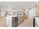 Modern kitchen featuring stainless steel appliances, stone countertops, and an open design with natural light at 1406 N Riverhills Dr, Temple Terrace, FL 33617