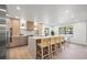 Bright kitchen features a large island with seating, stainless steel appliances, and stylish wood cabinets at 1406 N Riverhills Dr, Temple Terrace, FL 33617