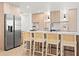 Modern kitchen features a large island with seating, stainless steel appliances, and stylish wood cabinets at 1406 N Riverhills Dr, Temple Terrace, FL 33617