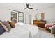 Bright main bedroom with modern decor, light wood floors, and ensuite bathroom at 1406 N Riverhills Dr, Temple Terrace, FL 33617