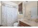 Bathroom featuring a tub with a shower curtain, a window, and a vanity sink at 14404 18Th E Pl, Bradenton, FL 34212
