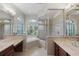 Bathroom featuring a soaking tub, a glass-enclosed shower, and double vanity sinks at 14404 18Th E Pl, Bradenton, FL 34212