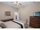 Neutral bedroom featuring dark wood furnishings and a closet accessible via a white door at 14404 18Th E Pl, Bradenton, FL 34212