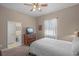Bedroom with a bed, dresser, and an ensuite bathroom at 14404 18Th E Pl, Bradenton, FL 34212