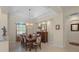Light-filled dining room with an elegant chandelier and direct access to the rest of the home at 14404 18Th E Pl, Bradenton, FL 34212