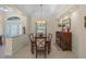 Formal dining room boasts elegant chandelier, decorative tray ceiling, and access to the front entrance at 14404 18Th E Pl, Bradenton, FL 34212