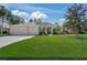 Charming single-story home featuring a three-car garage and well-manicured lawn with tropical landscaping at 14404 18Th E Pl, Bradenton, FL 34212