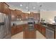 Gourmet kitchen features stainless appliances, granite countertops, rich wood cabinetry, and an island at 14404 18Th E Pl, Bradenton, FL 34212