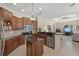 Gourmet kitchen with granite countertops and stainless appliances open to the living space at 14404 18Th E Pl, Bradenton, FL 34212