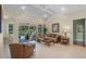 Cozy living room with lanai access, comfortable seating, and neutral tones creating a relaxing ambiance at 14404 18Th E Pl, Bradenton, FL 34212