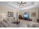 Bright living room with coffered ceiling and a wall of entertainment at 14404 18Th E Pl, Bradenton, FL 34212
